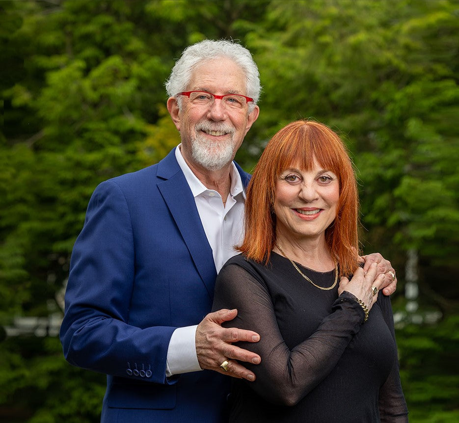 Dr Emily & Dr Mitchell Clionsky posing for a professional photo in front of some greenery